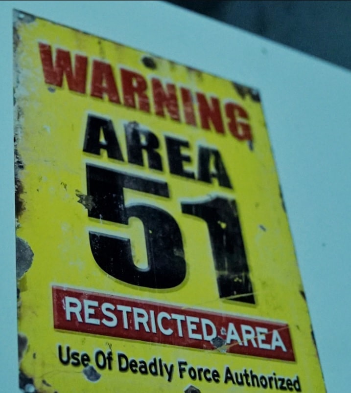 Yellow area 51 warning sign advertising for the Escape Room, The Visitors at Lockdown Ottawa Escape Rooms